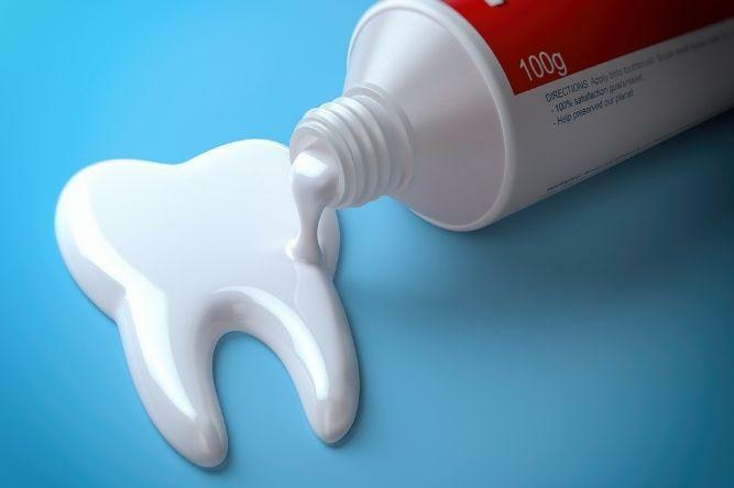 toothpaste being shaped into a tooth to remind you to protect your enamel.