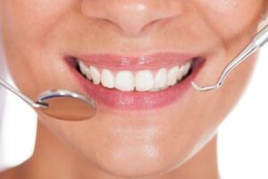 smiling to show how clean and proper teeth need to be
