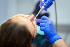 dentist has a tool to examine patients teeth